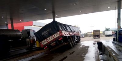 Carreta com carga de soja cai em rampa de lubrificação em posto de combustível de Camaquã